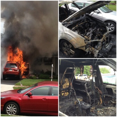 A car on fire in the driveway of a house